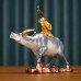 Color copper shepherd boy riding a bull